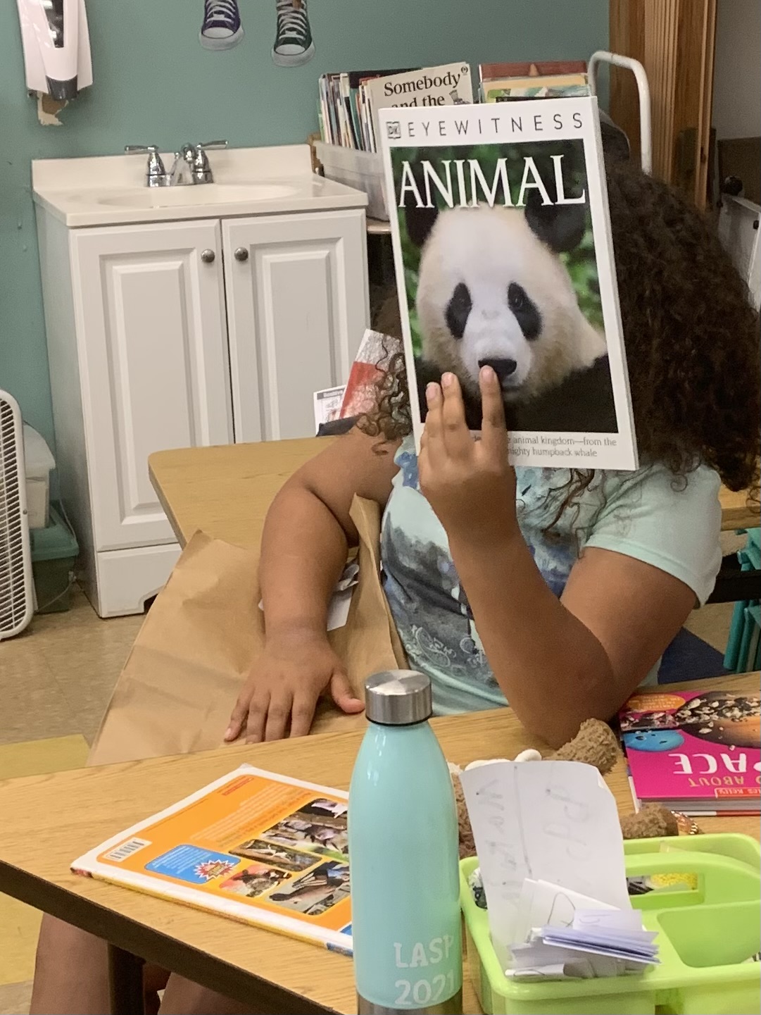 student holds up her new book about pandas